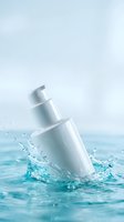 White cosmetic pump bottle splashing into clear blue water with dynamic droplets and ripples for skincare and beauty product advertising.