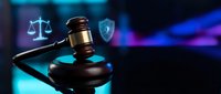 Judge's gavel with glowing scales of justice and shield icon on blue background. Legal services, law firm, attorney, courthouse, justice system.