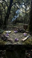 Mystical altar setup in forest with pentagram, amethyst crystals, burning incense, herbs and ritual tools for spiritual ceremonies and witchcraft practices.
