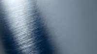 Brushed metal surface with diagonal grain texture and light reflection, suitable for industrial backgrounds, technology designs, and modern graphic projects.