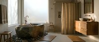 Luxurious spa-style bathroom with natural stone bathtub, wooden vanity, and warm ambient lighting creating serene wellness retreat atmosphere.