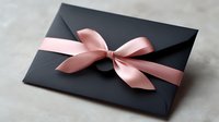 Elegant black envelope decorated with pink satin bow on neutral background, stylish minimal gift presentation for special occasions and celebrations.