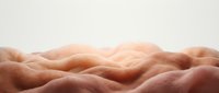 Soft, undulating flesh tones create an abstract landscape of human skin texture and form, suitable for wellness, body positivity, and sensual design projects.
