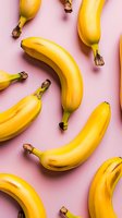 Fresh ripe bananas scattered on pink background creating modern food pattern. Trendy flat lay composition for healthy eating and tropical fruit concept.