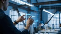 Professional businessman interacting with futuristic holographic interface displaying data analytics in modern office environment for business technology solutions.