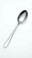 Single stainless steel spoon isolated on white background for kitchen utensil design and culinary graphics.