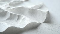 Minimalist white abstract wave surface with tiny black speckles creating dynamic texture and shadow play. Clean modern design background for presentations.