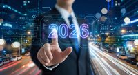Businessman touching glowing 2026 holographic display with digital interface elements and futuristic technology graphics in modern urban environment.