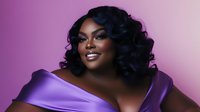 Confident plus size African American woman in elegant purple evening gown with glamorous makeup and curled hairstyle smiling against purple background.