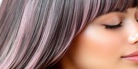 Asian woman with closed eyes and pink-tinted gray hair against light background, showcasing modern hair coloring and styling trends for beauty and salon marketing.