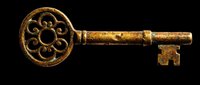 Ornate vintage skeleton key with decorative circular head and aged golden finish, isolated on transparent background. Ready for clipart, t-shirt design, print-on-demand products, stickers, and sublimation projects.