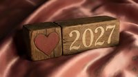 Wooden blocks with red heart and 2027 number on satin fabric background, isolated for Valentine's Day, love, romance, and New Year celebration designs.