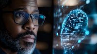 African American male scientist with glasses examining digital brain hologram with glowing neural networks in futuristic laboratory for AI research and development.