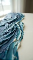 Thick blue acrylic paint texture with palette knife strokes on canvas surface for artistic backgrounds and creative projects.