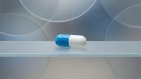 Blue and white pharmaceutical capsule pill on clean surface with soft bokeh background for medical healthcare and treatment concepts.