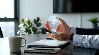 Businessman holding a glowing digital light bulb hologram above a tablet, symbolizing innovation, smart technology, and creative business solutions.