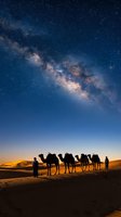 Desert caravan with camels and travelers under spectacular Milky Way galaxy in starry night sky over sand dunes at twilight for adventure travel concepts.