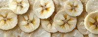 Sliced dried banana chips arranged in flat lay composition, showcasing natural tan and brown tones. Suitable for food photography, healthy snack marketing, and culinary content.