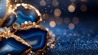 Blue agate crystal slice with golden edges on dark background with glitter and bokeh lights creating magical luxury mineral composition.