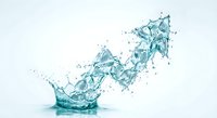 Dynamic water splash with turquoise liquid creating crown-like formation against white background for refreshing beverage and hydration concepts.