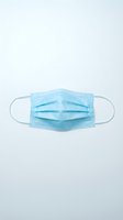 Disposable surgical face mask with elastic ear loops isolated on white background, ready for healthcare, medical, and safety design applications.
