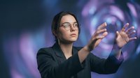 Young Caucasian businesswoman with glasses interacting with glowing virtual interface against abstract purple digital background.