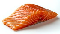Fresh raw salmon fillet with distinctive orange color and marbled texture on white background, showing natural fish meat pattern and omega-rich layers.