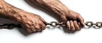 Elderly man hands bound with metal chain on white background showing captivity, restriction, slavery or human rights violation concept.