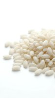 Pile of white short grain rice isolated on white background, suitable for food packaging, culinary websites, and nutrition content.