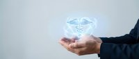 Healthcare professional holding glowing medical caduceus symbol, representing medicine, wellness, and healthcare services for medical industry concepts.
