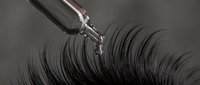 Professional eyelash curler tool creating dramatic curved lashes for makeup and beauty enhancement routine.