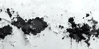 Abstract black and white ink splatter on textured surface creating dramatic contrast for modern artistic backgrounds.