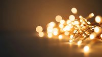 Warm glowing string lights with soft bokeh effect creating cozy ambient atmosphere for holiday decorations and festive celebrations.