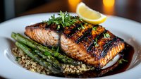 Grilled salmon fillet with honey-soy glaze served on quinoa with asparagus spears and lemon wedge garnish, drizzled with balsamic reduction sauce.