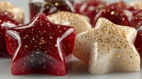 Festive star-shaped candles with glitter sparkles in red and cream colors for holiday decoration and Christmas celebration ambiance.