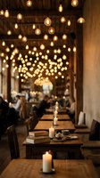 Cozy restaurant interior with warm Edison bulb string lights creating ambient atmosphere over wooden tables with candles for romantic dining experience.