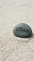 Smooth gray stone with engraved text resting on light sand background, symbolizing stress relief, mental health awareness, and wellness concepts for therapeutic and motivational design projects.