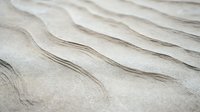 Minimalist abstract sand dunes texture with gentle wavy lines and neutral beige tones creates natural organic pattern for modern interior design background.