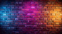 Colorful brick wall with vibrant neon lighting gradient from blue to pink to orange creating modern urban background texture for creative projects.
