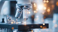 Close up view of microscope lens in modern laboratory with bokeh light effect background, scientific research and healthcare technology concept.