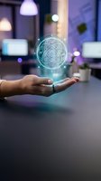 Hand holding glowing holographic atom symbol in modern office workspace. Represents science, technology, innovation, and future research concepts for business and educational applications.