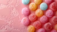 Colorful meringue cookies with swirled pattern in pastel pink, orange, and blue arranged on pink textured background. Sweet dessert food photography with copy space.