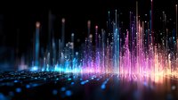 Glowing vertical light beams in blue, pink and orange colors rising from reflective surface against dark background create futuristic abstract visualization.