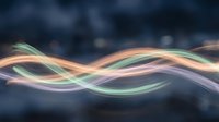 Abstract flowing waves with smooth colorful ribbons in green, orange and purple hues creating dynamic motion against dark blurred background for modern design.