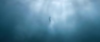 Ethereal figure standing alone in dense fog and mist, surrounded by atmospheric haze and soft light rays piercing through clouds, evoking mystery and solitude.