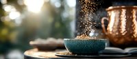 Steaming blue ceramic bowl on wooden table with copper kettle and golden sunlight creating warm morning atmosphere for cozy breakfast or tea time ritual.