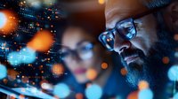Middle Eastern man with beard and glasses smiling while working on digital device at night, blue bokeh lights and data visualization elements create modern tech atmosphere.