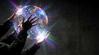 Hands reaching toward glowing holographic sphere with digital data streams and light effects against dark background for futuristic technology concepts.