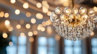 Elegant crystal chandelier with glass spheres and golden elements against blurred bokeh background in luxury interior.