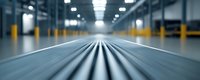 Blurred motion perspective of industrial conveyor belt system in modern warehouse facility with selective focus on moving lines and bokeh lighting effects.